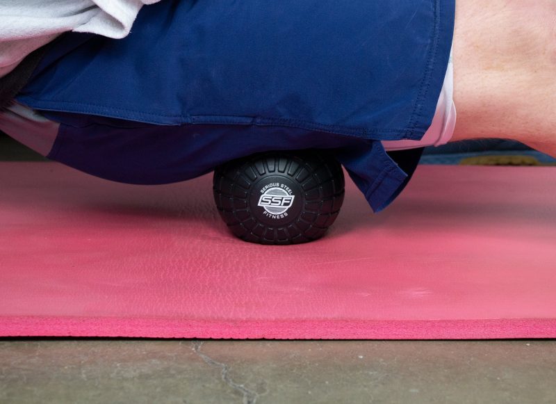 SSF Black Massage Ball In Use On Yoga Mat Pink 1